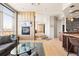 Bright living room with a fireplace, hardwood floors, and modern kitchen at 2000 Little Raven St # 501, Denver, CO 80202