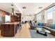 Open concept living room and kitchen with large windows, modern decor, and hardwood floors at 2000 Little Raven St # 501, Denver, CO 80202