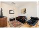 Cozy living room features a leather couch, accent chair and patterned rug at 2000 Little Raven St # 501, Denver, CO 80202