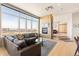Spacious living room with a fireplace, large windows offering city views, and an open floor plan at 2000 Little Raven St # 501, Denver, CO 80202
