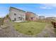 Spacious backyard featuring a well-kept lawn, patio area, and fencing, creating a private and peaceful retreat at 4811 River Highlands Loop, Elizabeth, CO 80107