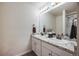 Well-lit bathroom featuring double sinks with granite counters, modern fixtures, and a glass-enclosed shower at 4811 River Highlands Loop, Elizabeth, CO 80107