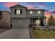 Charming two-story home with a welcoming front porch and two-car garage with manicured lawn and fresh landscaping at 4811 River Highlands Loop, Elizabeth, CO 80107