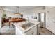 Spacious kitchen featuring an island with a stainless steel sink that opens to the dining and living room at 4811 River Highlands Loop, Elizabeth, CO 80107