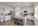Well-lit kitchen with stainless steel appliances, granite counters, and a center island with seating at 4811 River Highlands Loop, Elizabeth, CO 80107