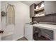 Convenient laundry room equipped with a washer, dryer, modern cabinetry and shelving for ample storage at 4811 River Highlands Loop, Elizabeth, CO 80107