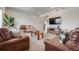 Comfortable living room with neutral carpet, wainscoting, and modern media center with seamless flow to the stairs at 4811 River Highlands Loop, Elizabeth, CO 80107