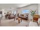 Inviting living room showcasing neutral tones, carpet floors, an abundance of natural light, and open concept design at 4811 River Highlands Loop, Elizabeth, CO 80107