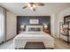 Elegant main bedroom with a blue accent wall, comfortable bedding, and decorative accents at 4811 River Highlands Loop, Elizabeth, CO 80107