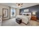 Tranquil main bedroom with a navy accent wall, large window, and stylish decor at 4811 River Highlands Loop, Elizabeth, CO 80107