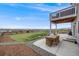 Outdoor patio with a dining set, offering a perfect spot for al fresco meals with views of the backyard at 4811 River Highlands Loop, Elizabeth, CO 80107