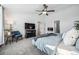 Well-lit bedroom featuring a decorative fireplace, ceiling fan, and large area rug at 5547 S Urban St, Littleton, CO 80127