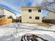 View of the home's backyard with snow and grass at 13577 Quivas St, Denver, CO 80234