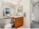 The bathroom is equipped with a single vanity and a toilet, illuminated by a row of vanity lights at 13577 Quivas St, Denver, CO 80234