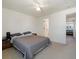 Comfortable bedroom featuring a queen-size bed with neutral bedding and a view to another room at 13577 Quivas St, Denver, CO 80234