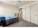 Bedroom featuring neutral walls, a ceiling fan, closet, carpeted flooring, and ample space at 13577 Quivas St, Denver, CO 80234