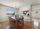 Inviting dining area with a modern light fixture and seamless flow into the kitchen at 13577 Quivas St, Denver, CO 80234