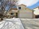 Charming two-story home with a well-maintained lawn and attached two-car garage at 13577 Quivas St, Denver, CO 80234