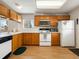 Functional kitchen featuring wood cabinets, white countertops, and a practical design at 13577 Quivas St, Denver, CO 80234