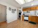 This kitchen features wood cabinets, white countertops, and laminate flooring providing a practical cooking space at 13577 Quivas St, Denver, CO 80234