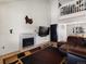 Spacious living room with a cozy fireplace and seamless connection to the dining area at 13577 Quivas St, Denver, CO 80234