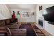 Inviting living room with a cozy fireplace, comfortable seating, and natural light at 13577 Quivas St, Denver, CO 80234