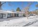 Home exterior showcasing snowy backyard and patio at 2761 S Xanadu Way, Aurora, CO 80014