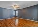 Bedroom featuring hardwood floors, ceiling fan, and blue painted walls at 2761 S Xanadu Way, Aurora, CO 80014