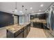 Open kitchen with dark wood cabinets, granite countertops, and stainless steel appliances at 2761 S Xanadu Way, Aurora, CO 80014