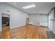Open-concept living room with hardwood floors, a skylight, and a neutral color scheme throughout at 2761 S Xanadu Way, Aurora, CO 80014