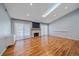 Spacious living room boasts hardwood floors, a skylight, and a charming white-tiled fireplace at 2761 S Xanadu Way, Aurora, CO 80014
