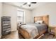Comfortable bedroom with wood floors, a ceiling fan, a large bed, and storage shelves at 3370 Cascina Cir # D, Highlands Ranch, CO 80126