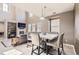 Open-concept dining room with a stylish table and chairs, bright natural light, and fireplace at 3370 Cascina Cir # D, Highlands Ranch, CO 80126