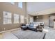 Modern living room with high ceilings, large windows, comfortable seating, and an area rug at 3370 Cascina Cir # D, Highlands Ranch, CO 80126