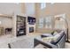 Cozy living room featuring a fireplace, mounted TV, a storage shelf, and lots of light at 3370 Cascina Cir # D, Highlands Ranch, CO 80126