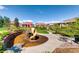 An inviting neighborhood playground with a slide set amidst lush landscaping and trees at 3370 Cascina Cir # D, Highlands Ranch, CO 80126