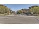 A street view showcases a well-maintained streetscape with trees, signage, and houses at 3370 Cascina Cir # D, Highlands Ranch, CO 80126