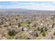 Beautiful aerial showcasing the neighborhood and surrounding green spaces under a clear sky at 3355 S Flower St # 131, Lakewood, CO 80227