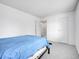 Carpeted bedroom features minimalist decor, natural light, and white walls at 3355 S Flower St # 131, Lakewood, CO 80227