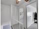 Upstairs hallway with carpet flooring, louvered closet doors, and access to bedrooms at 3355 S Flower St # 131, Lakewood, CO 80227