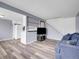 Living room boasts modern gray walls, sleek flooring, and a staircase with white railings at 3355 S Flower St # 131, Lakewood, CO 80227