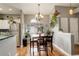 Bright dining area featuring wood floors, chandelier, and large window with plants at 8422 S Upham Way # H75, Littleton, CO 80128