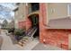 Charming entrance with brick accents, stairs, and well-maintained landscaping, showcasing the building's inviting appeal at 8422 S Upham Way # H75, Littleton, CO 80128