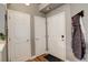 Bright hallway with hardwood floors and multiple doors, creating a welcoming entrance at 8422 S Upham Way # H75, Littleton, CO 80128