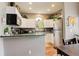 Cozy kitchen with stainless steel refrigerator, white cabinets and green countertops at 8422 S Upham Way # H75, Littleton, CO 80128