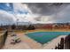 Community pool with a covered pool, seating, and mountain views at 8422 S Upham Way # H75, Littleton, CO 80128