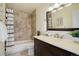 Cozy bathroom features a shower, decorative shower curtain, and dark wood vanity at 8487 Everett Way # E, Arvada, CO 80005