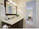 Bathroom with a vanity, framed mirror, and stylish accessories adjacent to the bedroom at 8487 Everett Way # E, Arvada, CO 80005