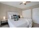 Comfortable bedroom with a ceiling fan and plush bedding, next to mirrored closet doors at 8487 Everett Way # E, Arvada, CO 80005