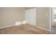 Neutral bedroom features a closet and beige carpet at 8487 Everett Way # E, Arvada, CO 80005